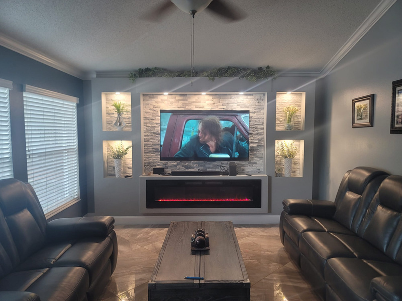 Interior living room with stacked stone and crown molding accent wall