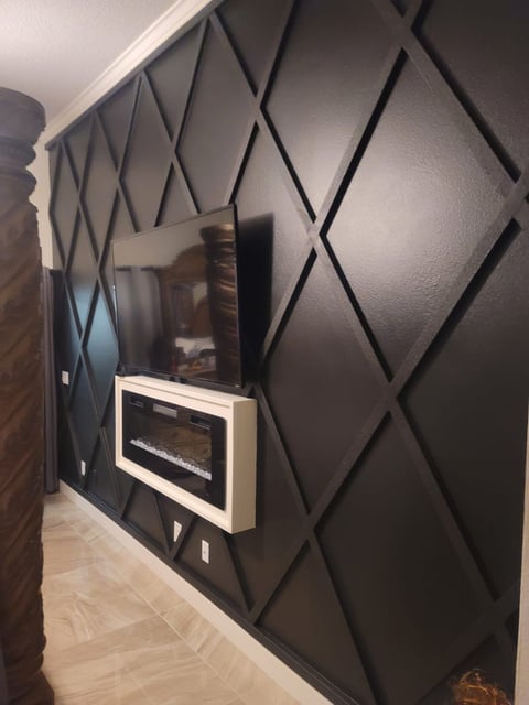 Modern interior accent wall with geometric foam molding and fireplace