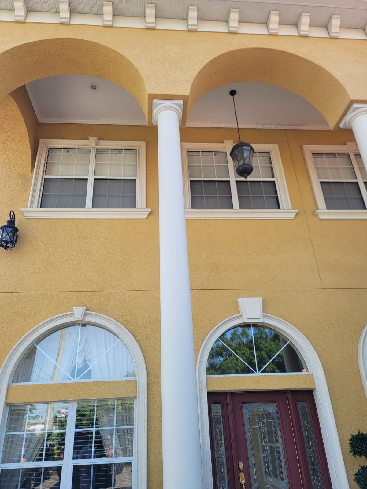 Home entrance with round foam columns and arched window trims